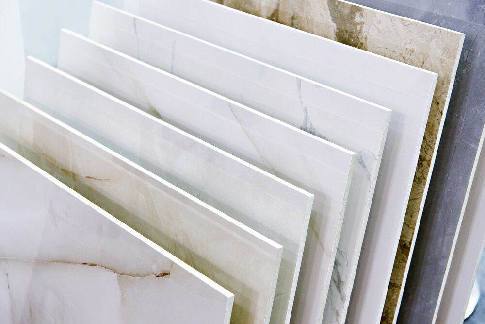 A Variety Of Tiles Are Stacked On Top Of Each Other In A Store — Mid Coast Tiles Urunga In Urunga, NSW