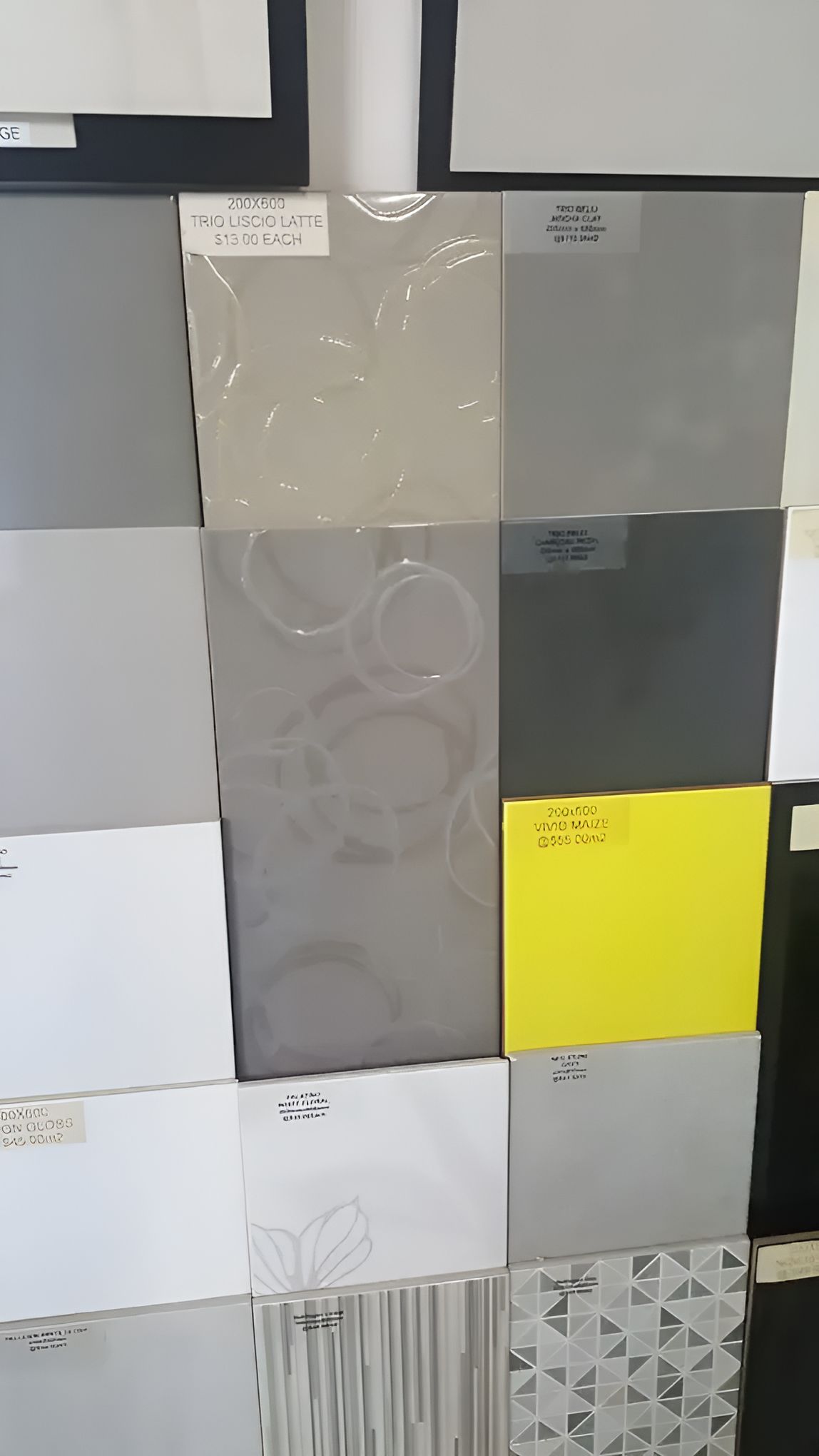 A Bunch Of Different Colored Tiles Are Stacked On Top Of Each Other — Mid Coast Tiles Urunga In Urunga, NSW