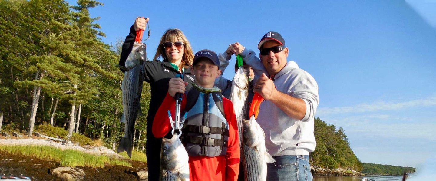 A Happy Family With Their Freshly Caught Fish