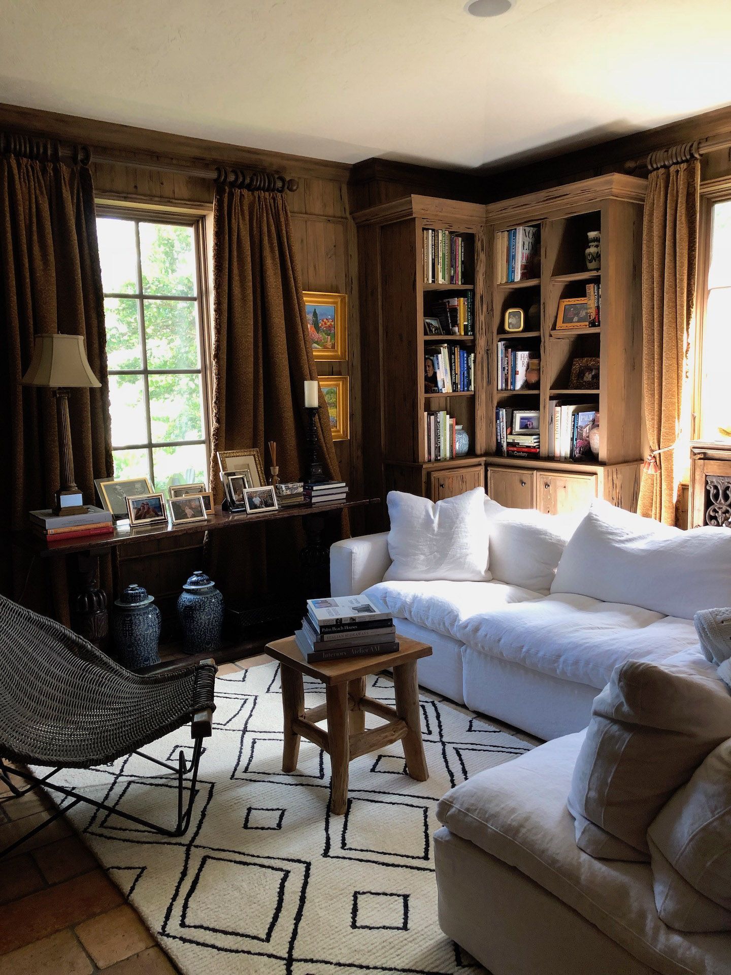 A living room with a white couch and a rug