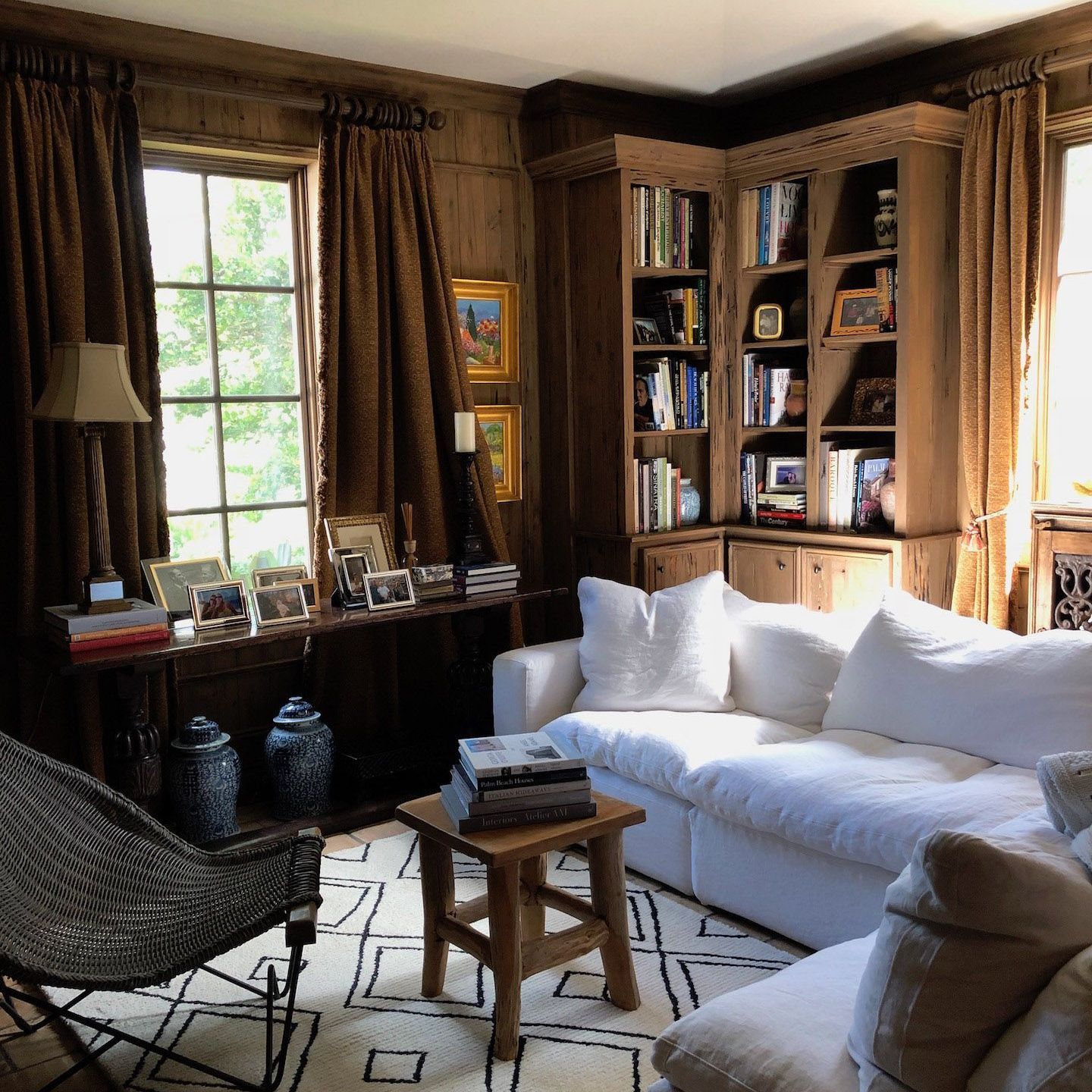 A living room with a white couch and a chair