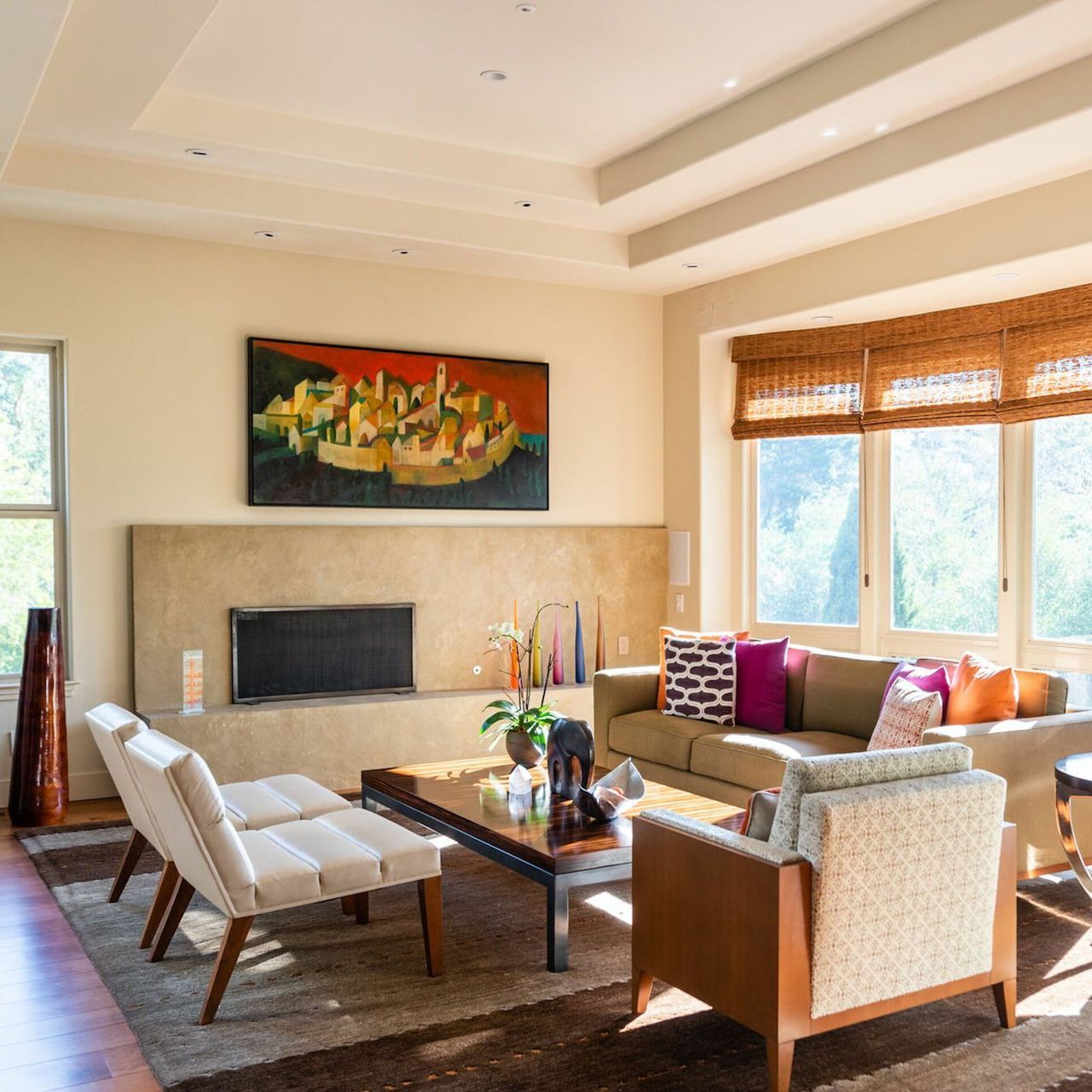 A living room with a couch and chairs and a fireplace