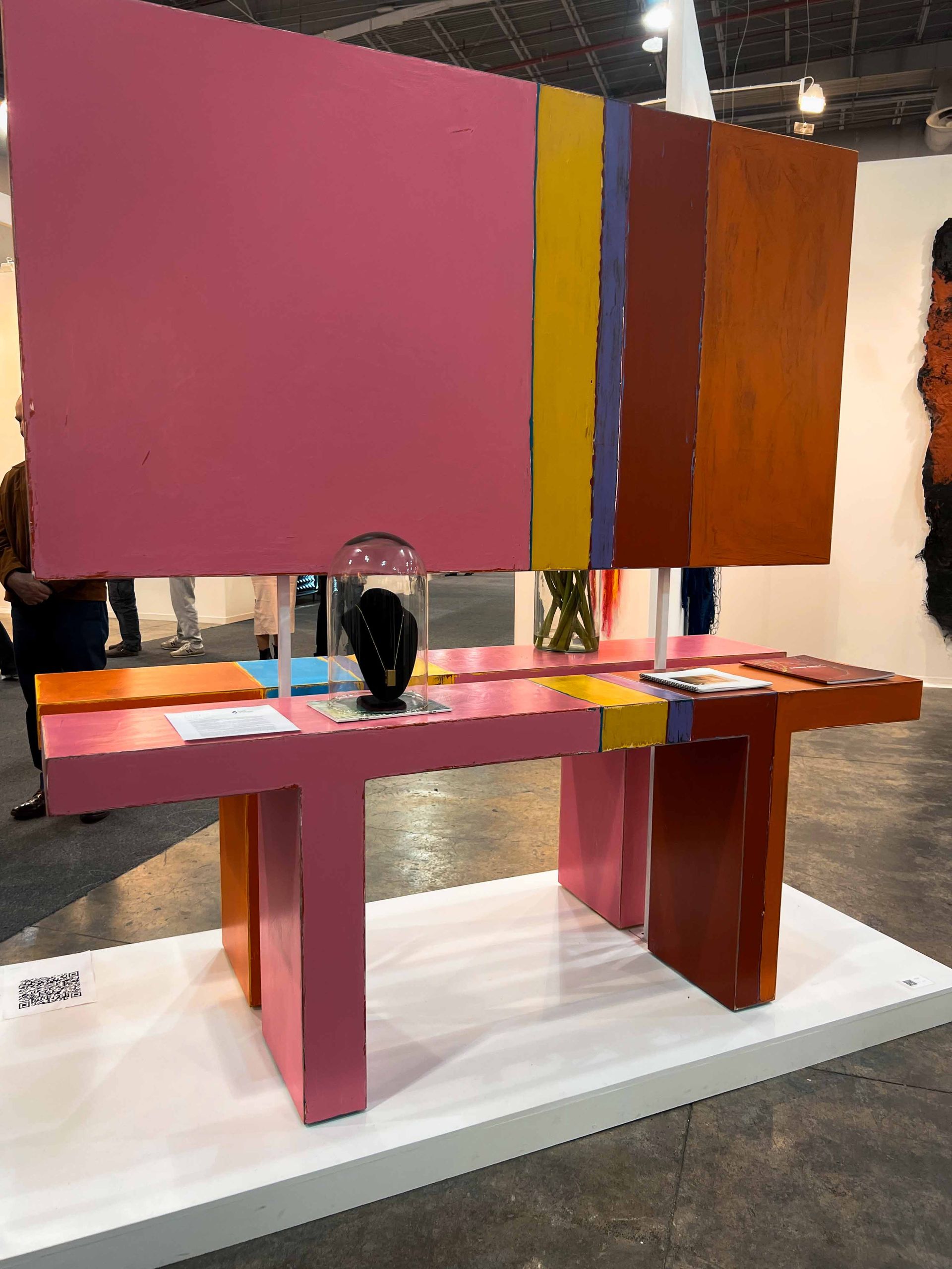 A colorful sculpture is sitting on a table in a room.