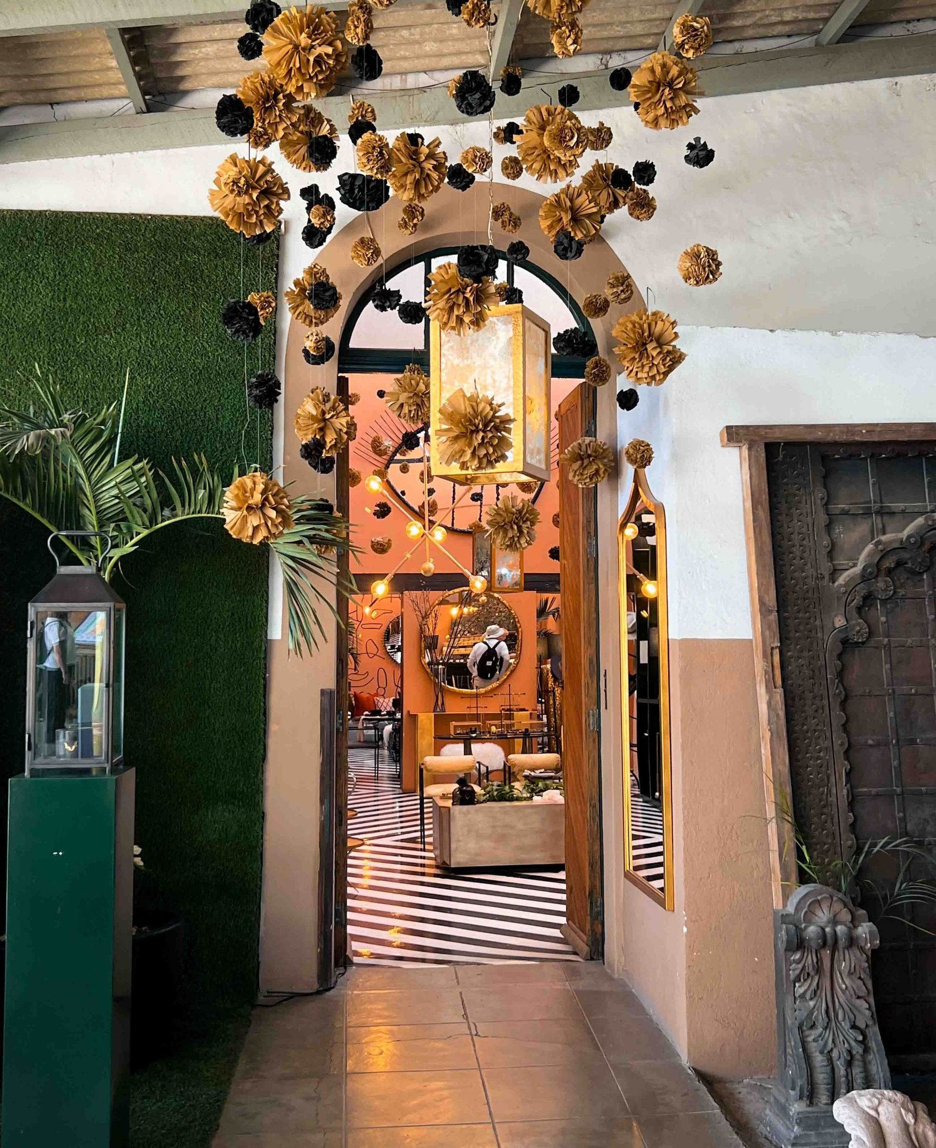 A hallway with flowers hanging from the ceiling