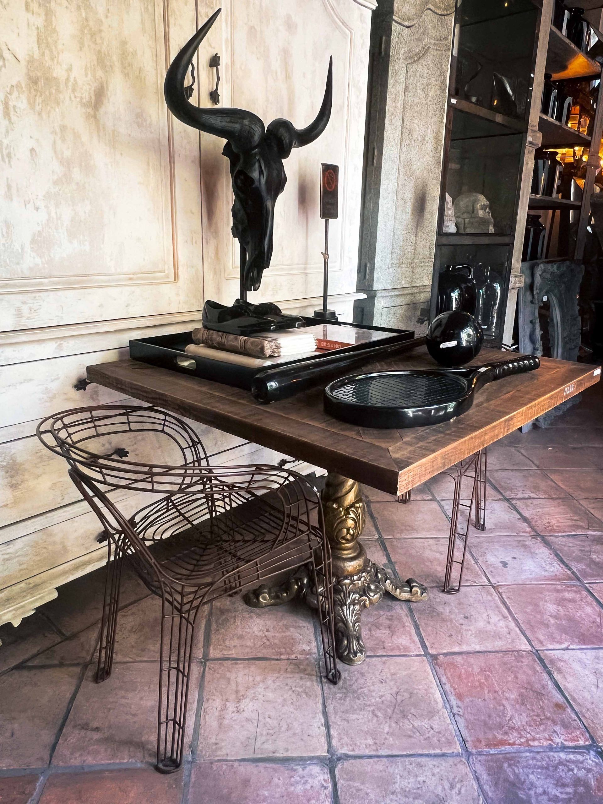 A wooden table with a statue of a bull on top of it.