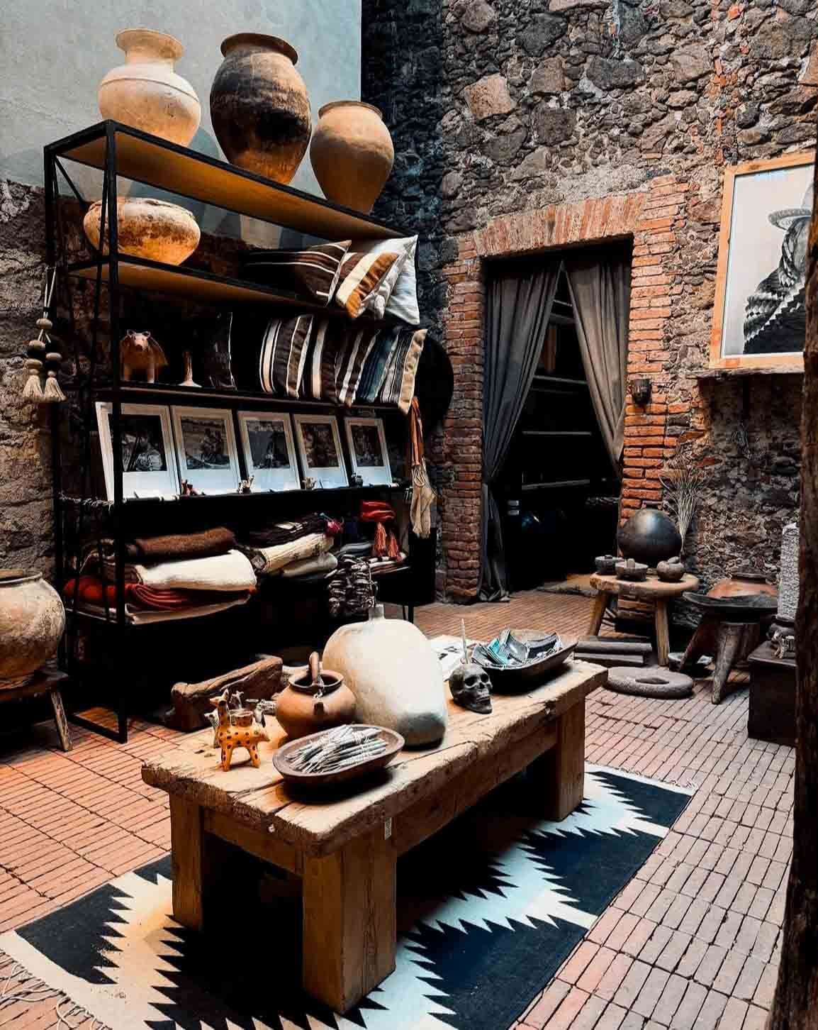 A living room with a wooden table and a rug.