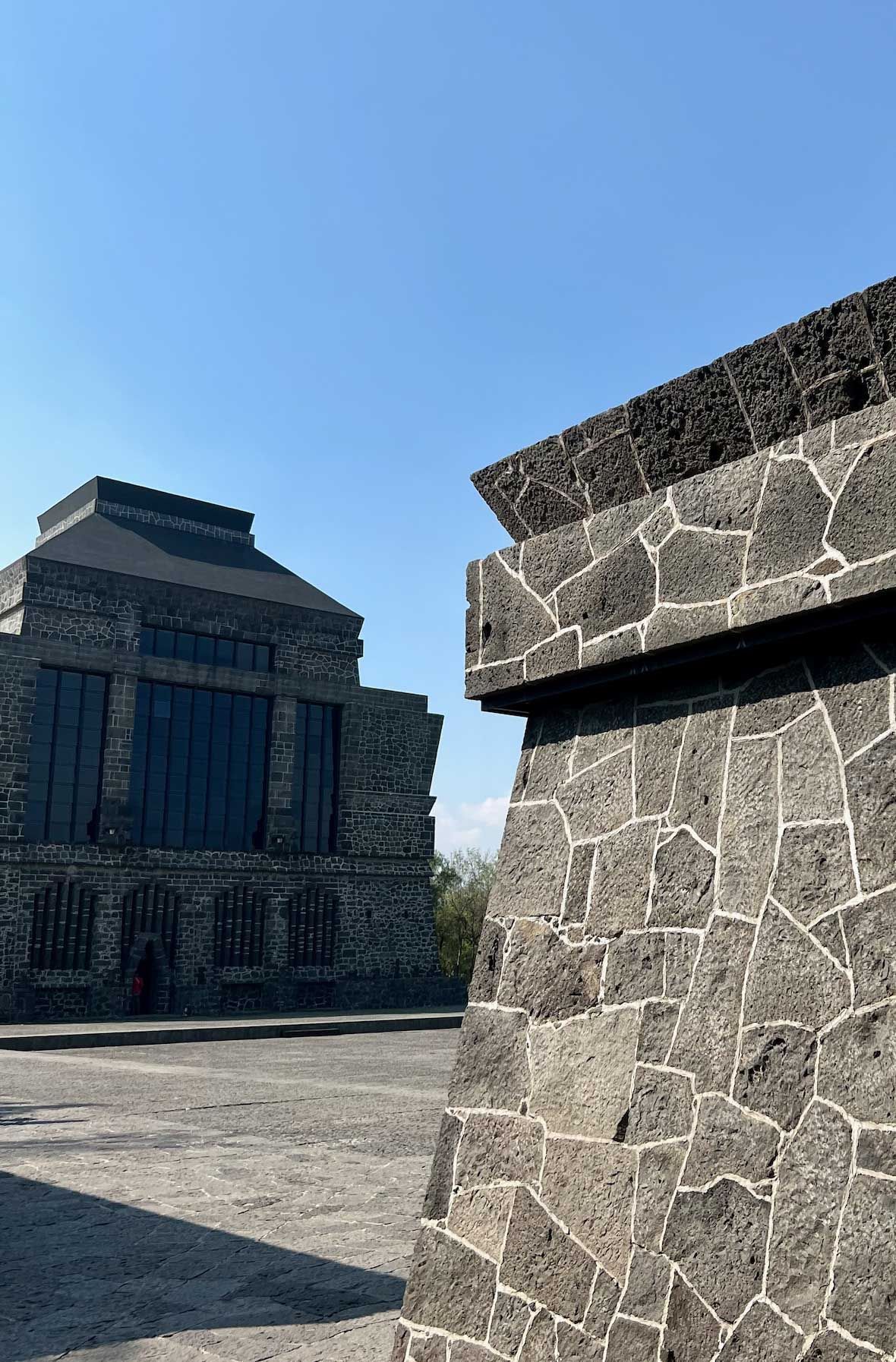 A large stone building with a blue sky in the background.