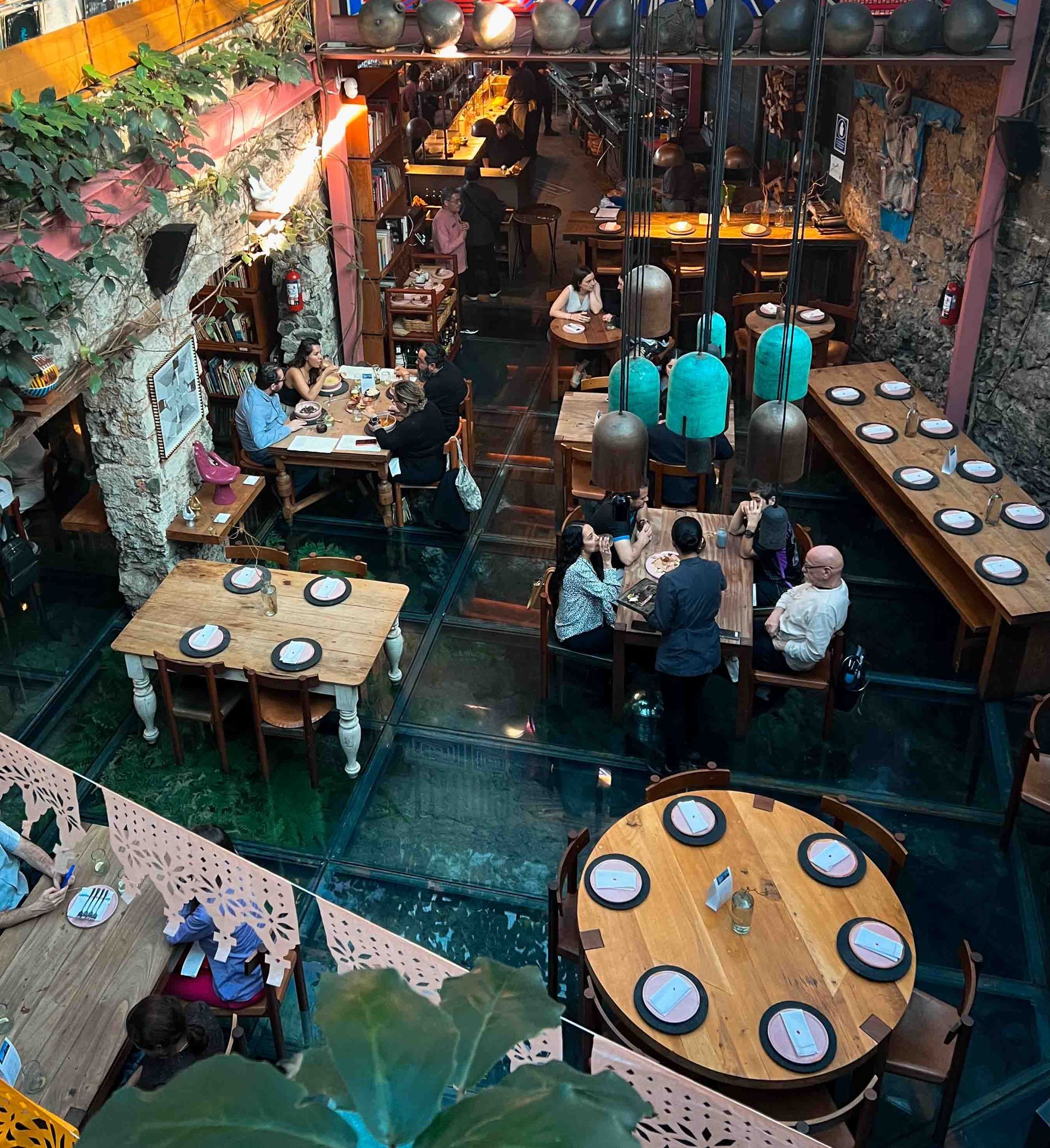 A group of people are sitting at tables in a restaurant
