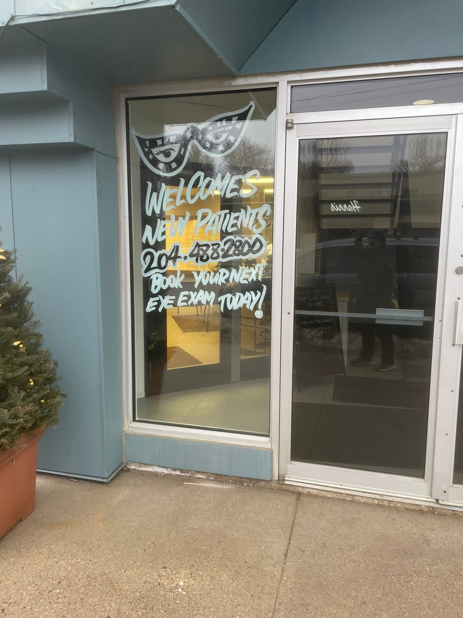 The front door of a building with a welcome sign on it.