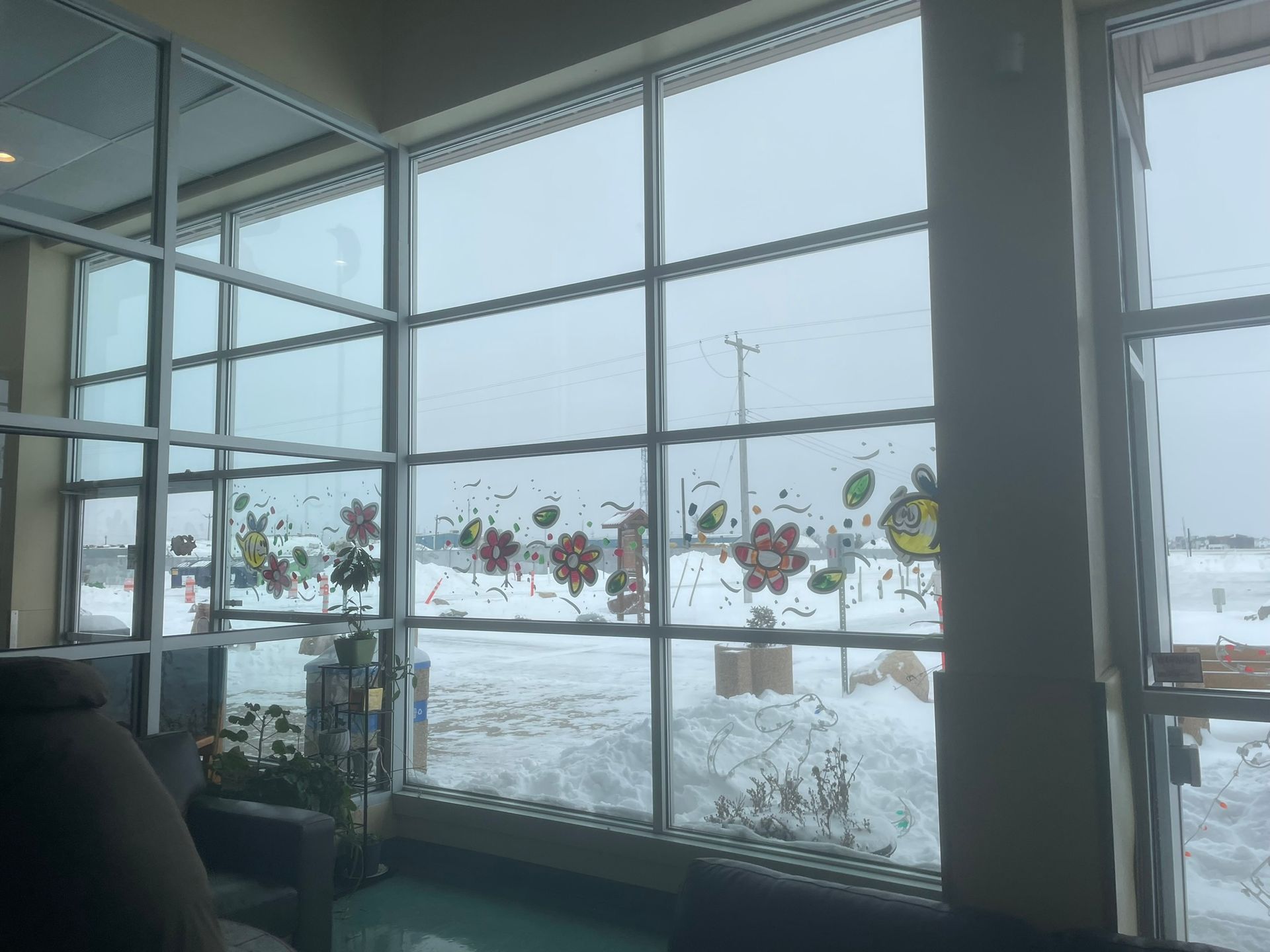 A room with a lot of windows and snow outside