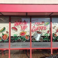 A restaurant with a lot of signs on the windows.