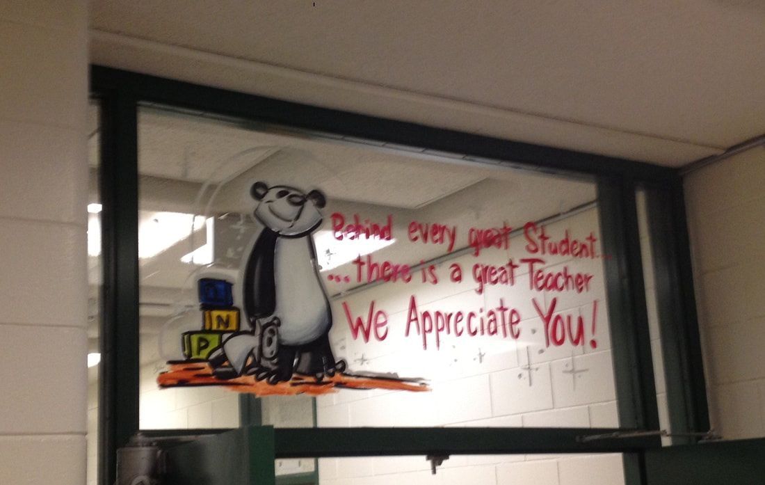 A window with a picture of a bear and the words