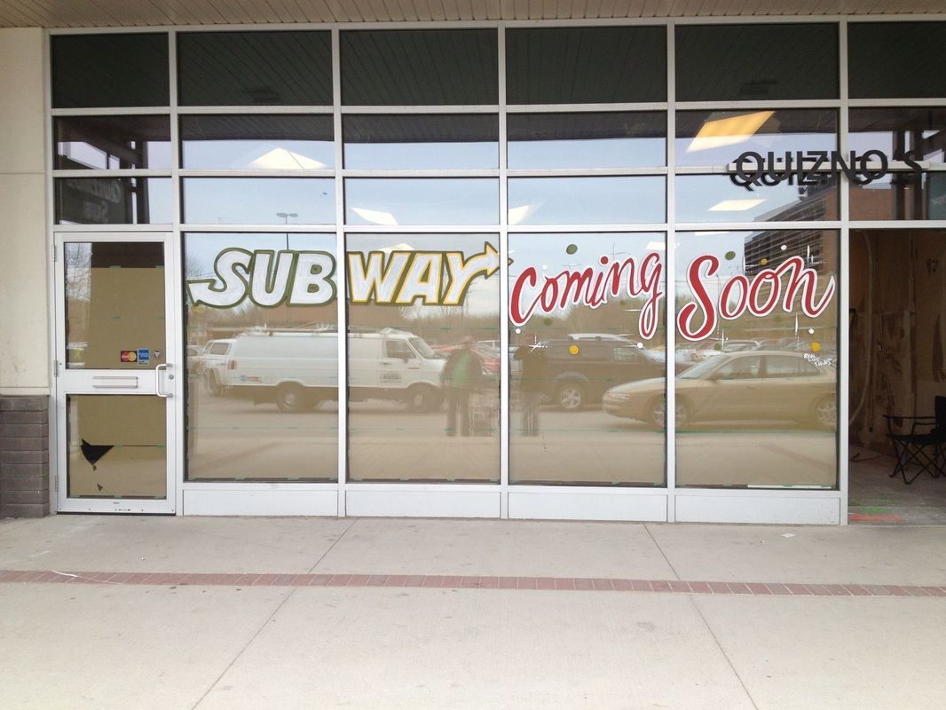 Subway is coming soon on the window of a building