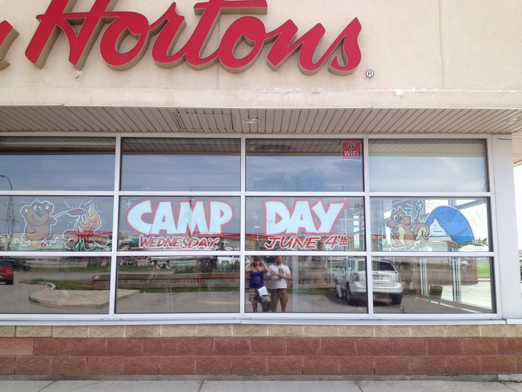 A store front with a sign that says camp day