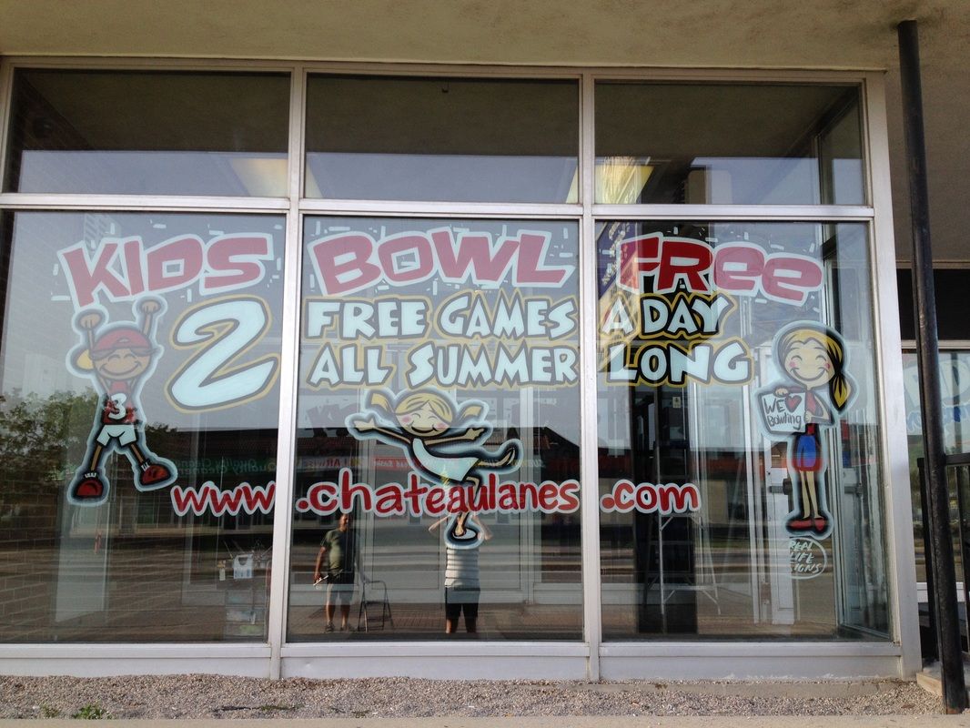 A window with a sign that says kids bowl free 2 free games a day all summer long