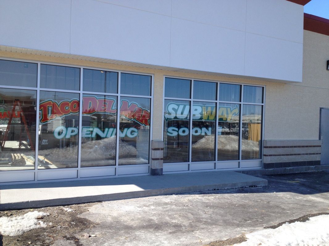 A store front with subway written on the windows