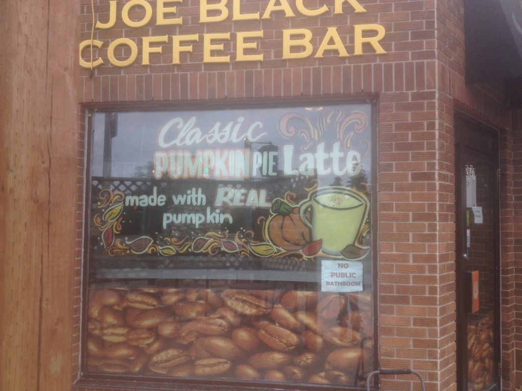 A brick building with a sign that says joe black coffee bar