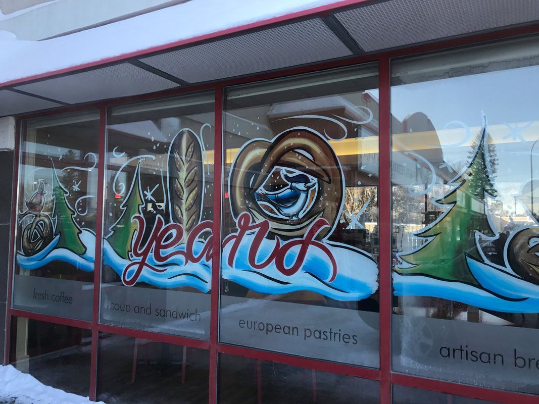 A store front with a painting on the window that says yeard