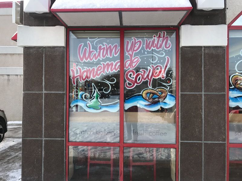 A store front with a sign that says warm up with homemade soup