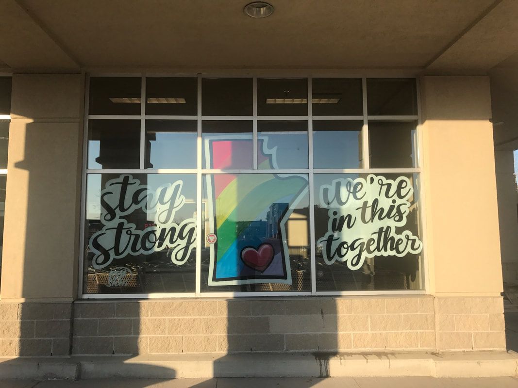 A window that says stay strong and we 're in this together
