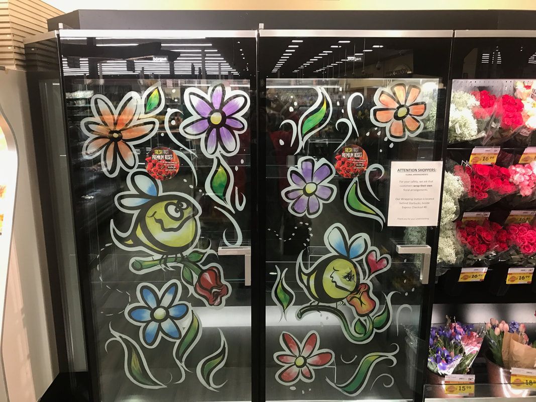 A display case with flowers painted on it in a store.