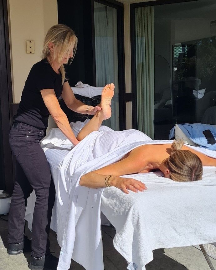Woman Receiving a Foot Treatment, Feet Soaking in A White Basin — Soul Good Beauty in Miami, QLD