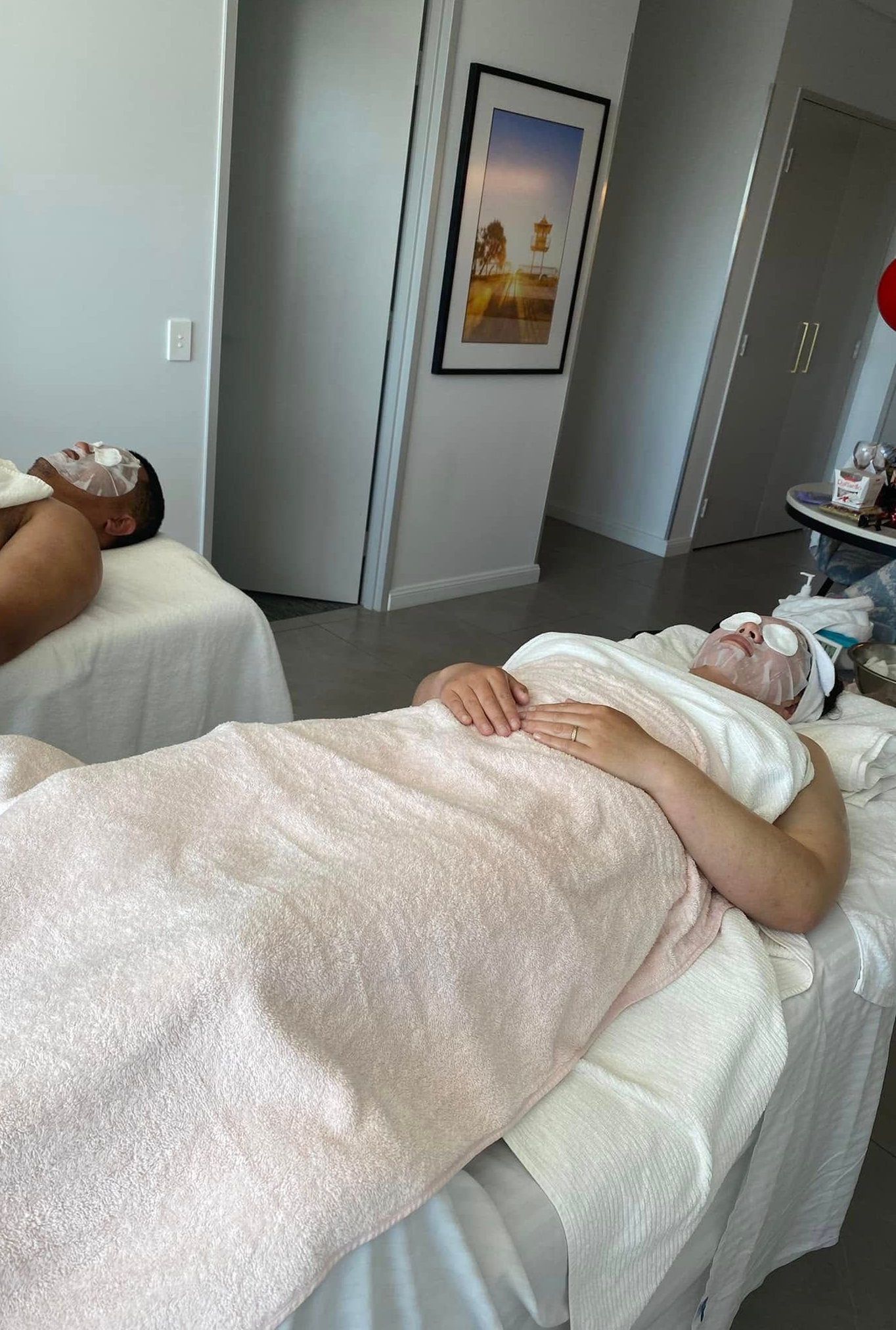 Two People Receiving Massages in A Spa, Lying on Massage Tables — Soul Good Beauty in Miami, QLD