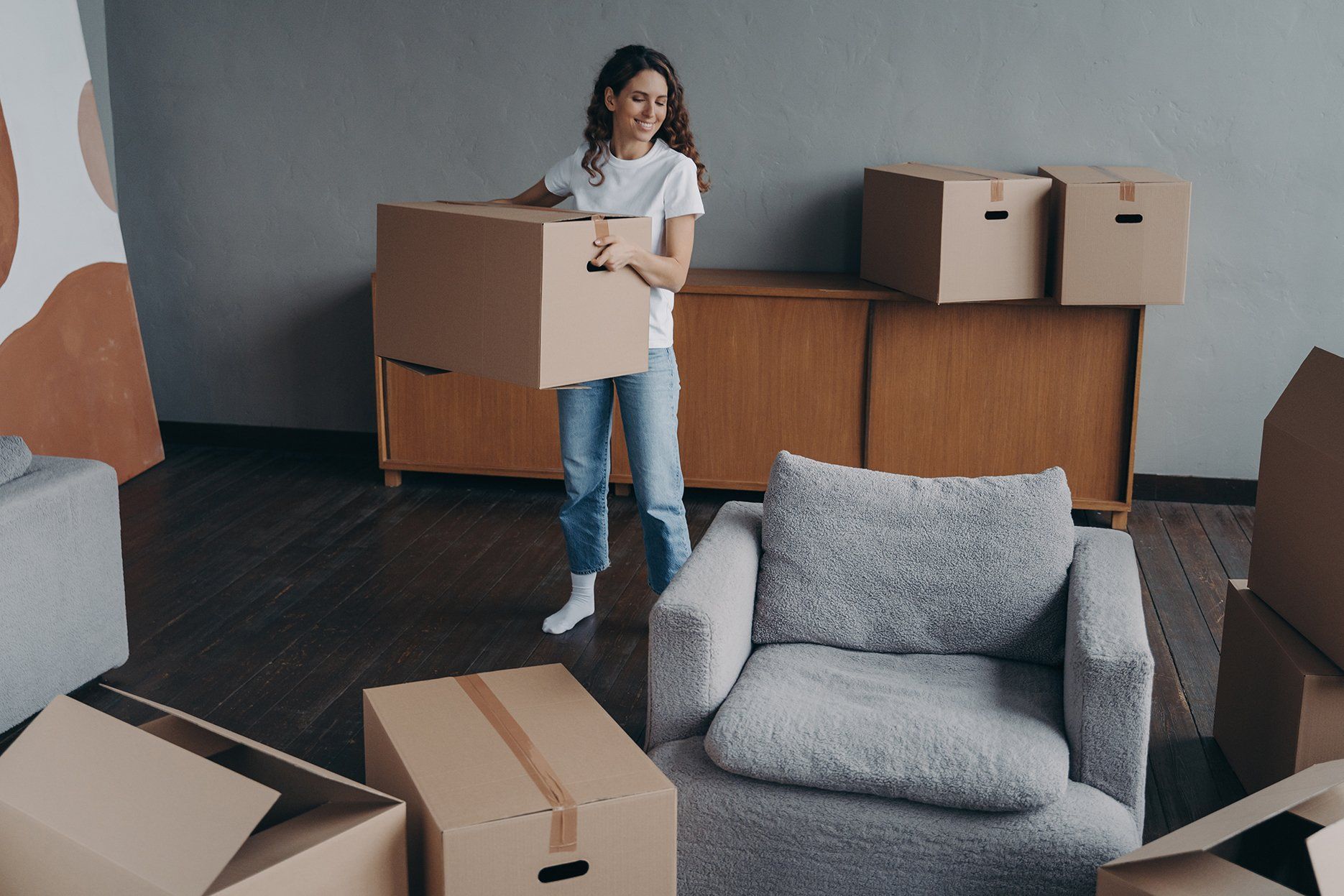 hispanic girl holding box leaving apartment
