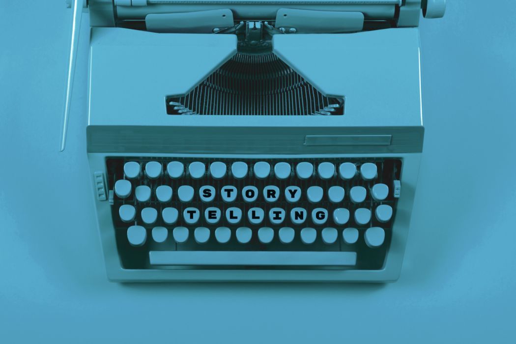 Blue vintage typewriter front view with round keys on a light blue background