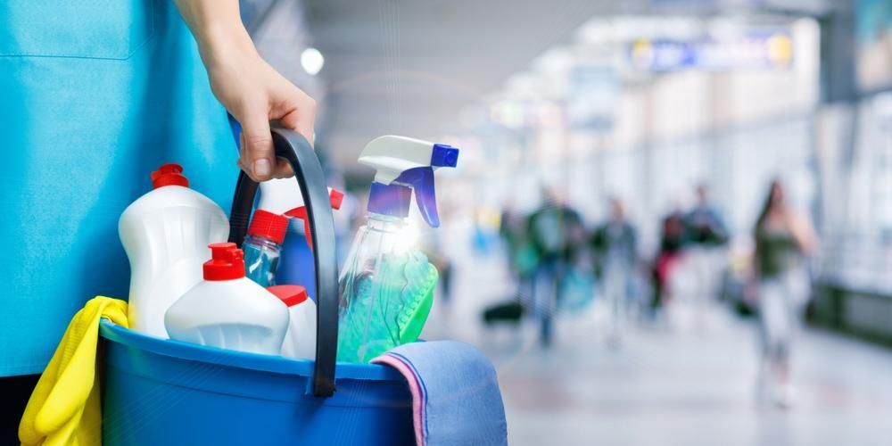 Person is Holding a Blue Bucket Filled With Cleaning Supplies — Active Cleaning Service Newcastle, NSW