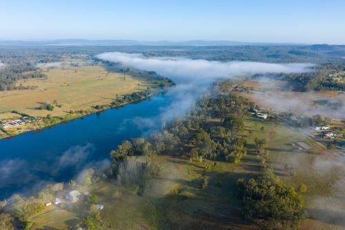 Aerial View of a River Surrounded by Trees and Fog — Active Cleaning Service Cessnock, NSW