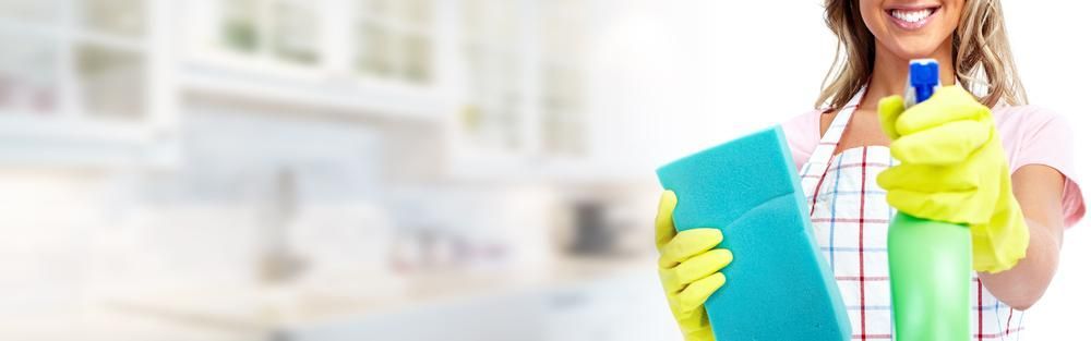 Woman in Yellow Gloves is Holding a Sponge and a Spray Bottle — Active Cleaning Service Newcastle, NSW