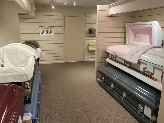 Bedroom furniture display with two upholstered beds in a beige showroom