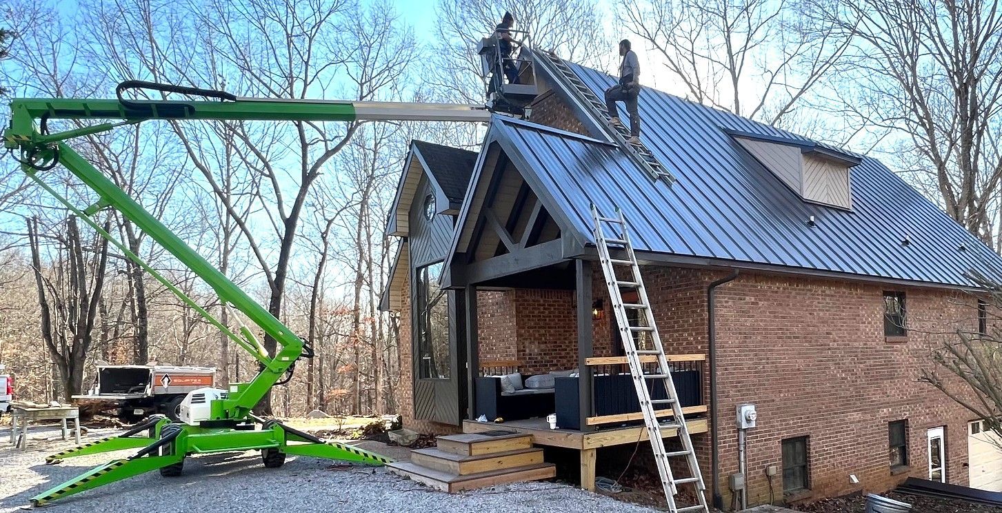 Roofers showcasing roof replacement by removing old material for storm damage repair.