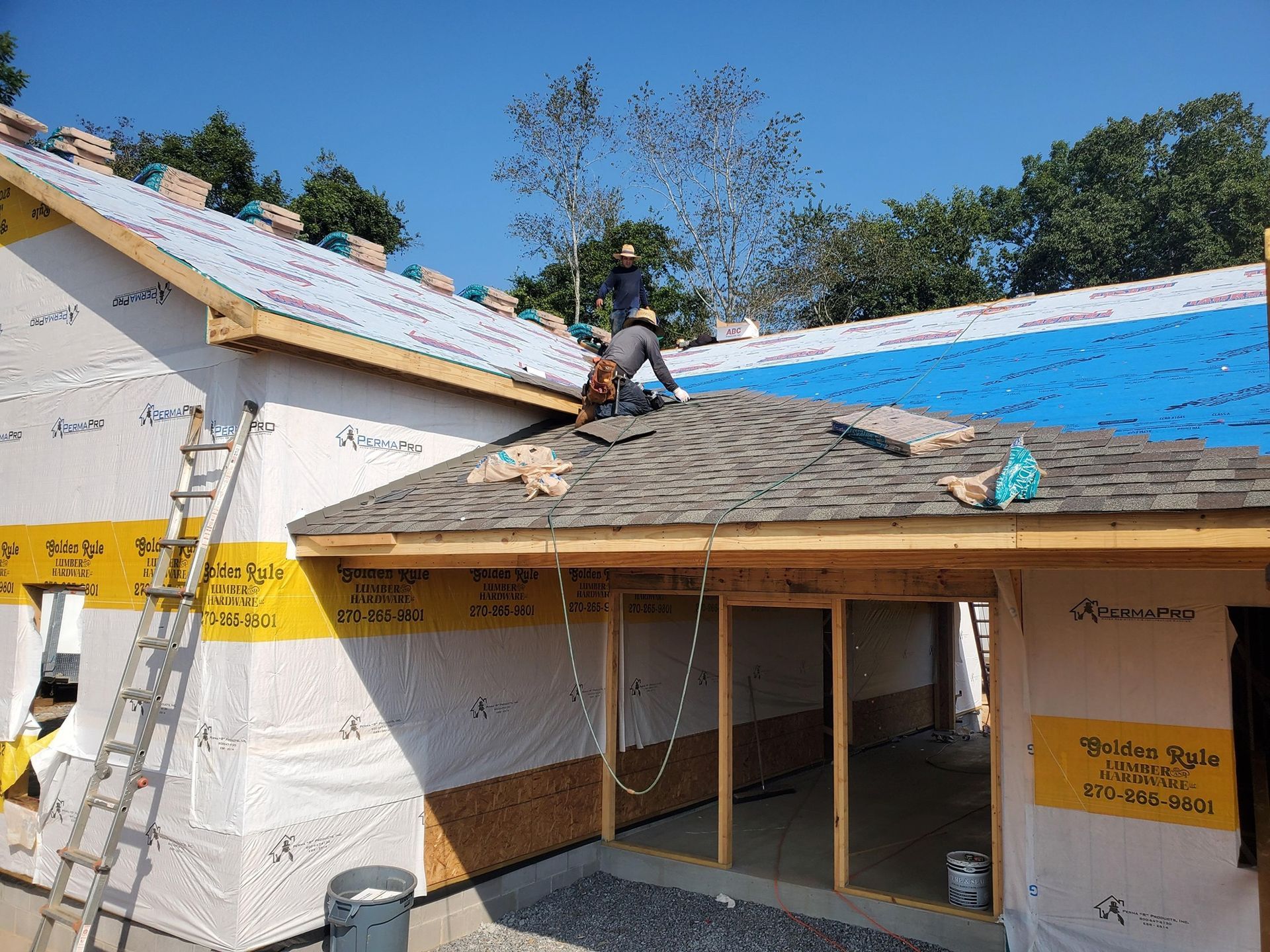 Gray asphalt roof shingles with a ridge vent along the rooftop.