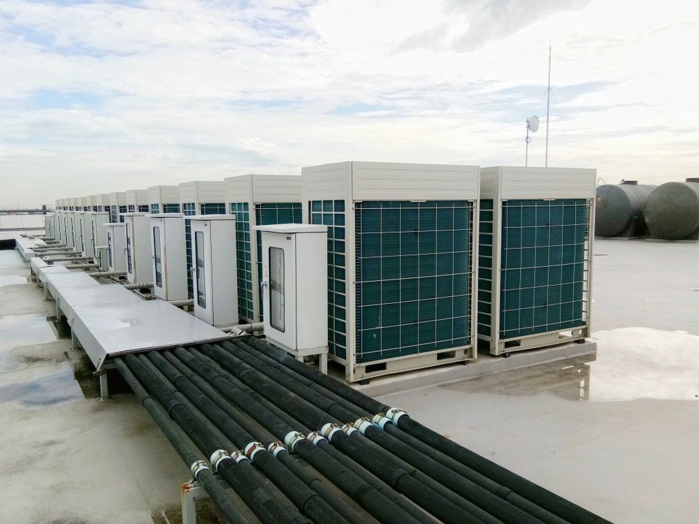 A Row Of Air Conditioners Are Sitting On Top Of A Roof — Aircon Mid North Coast in Coffs Harbour, NSW