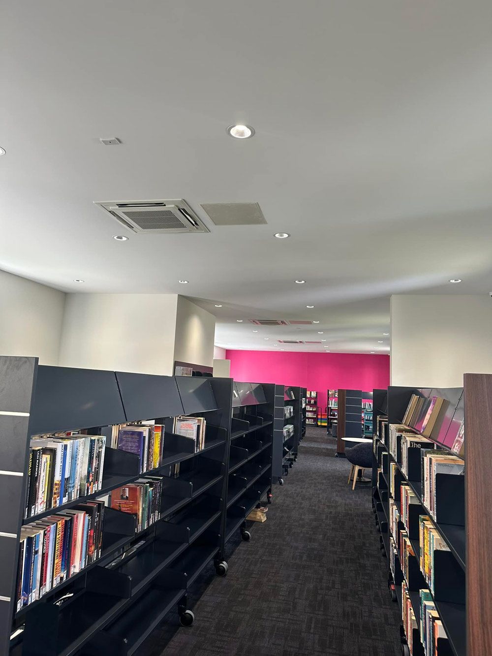 Black Bookshelves With Air Conditioner — Aircon Mid North Coast in Forster, NSW