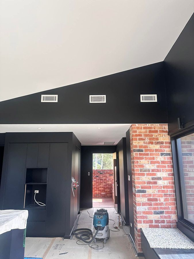 A Room With A Vacuum Cleaner In It And A Brick Wall — Aircon Mid North Coast in Hallidays Point, NSW