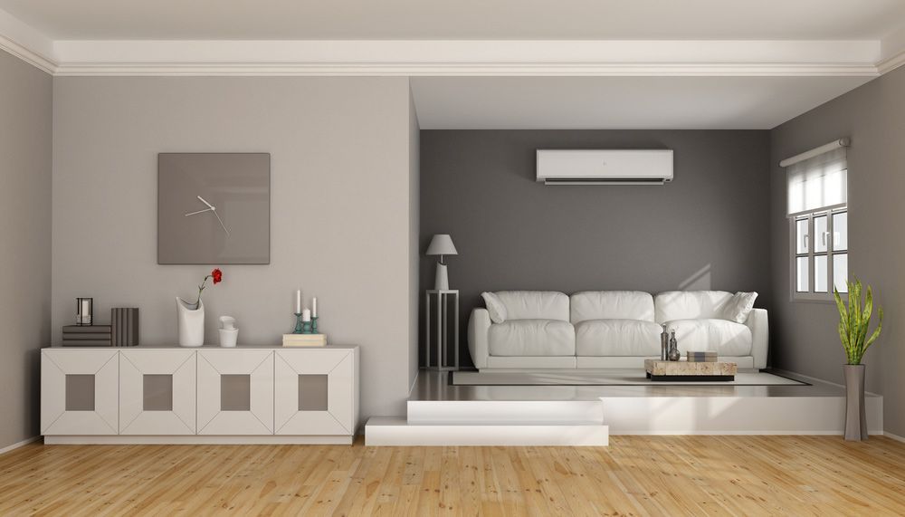 A Living Room With A Couch And A Clock On The Wall — Air Conditioning Electricians in Port Stephens, NSW