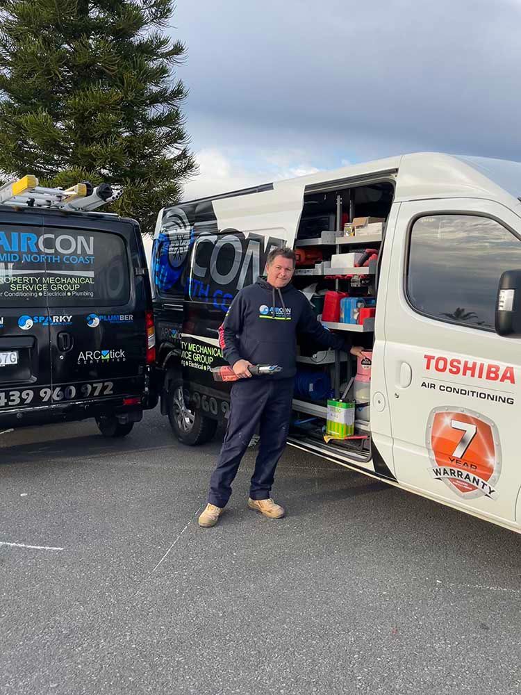 Man Standing In Front Of A Company Vehicle — Aircon Mid North Coast in Forster, NSW