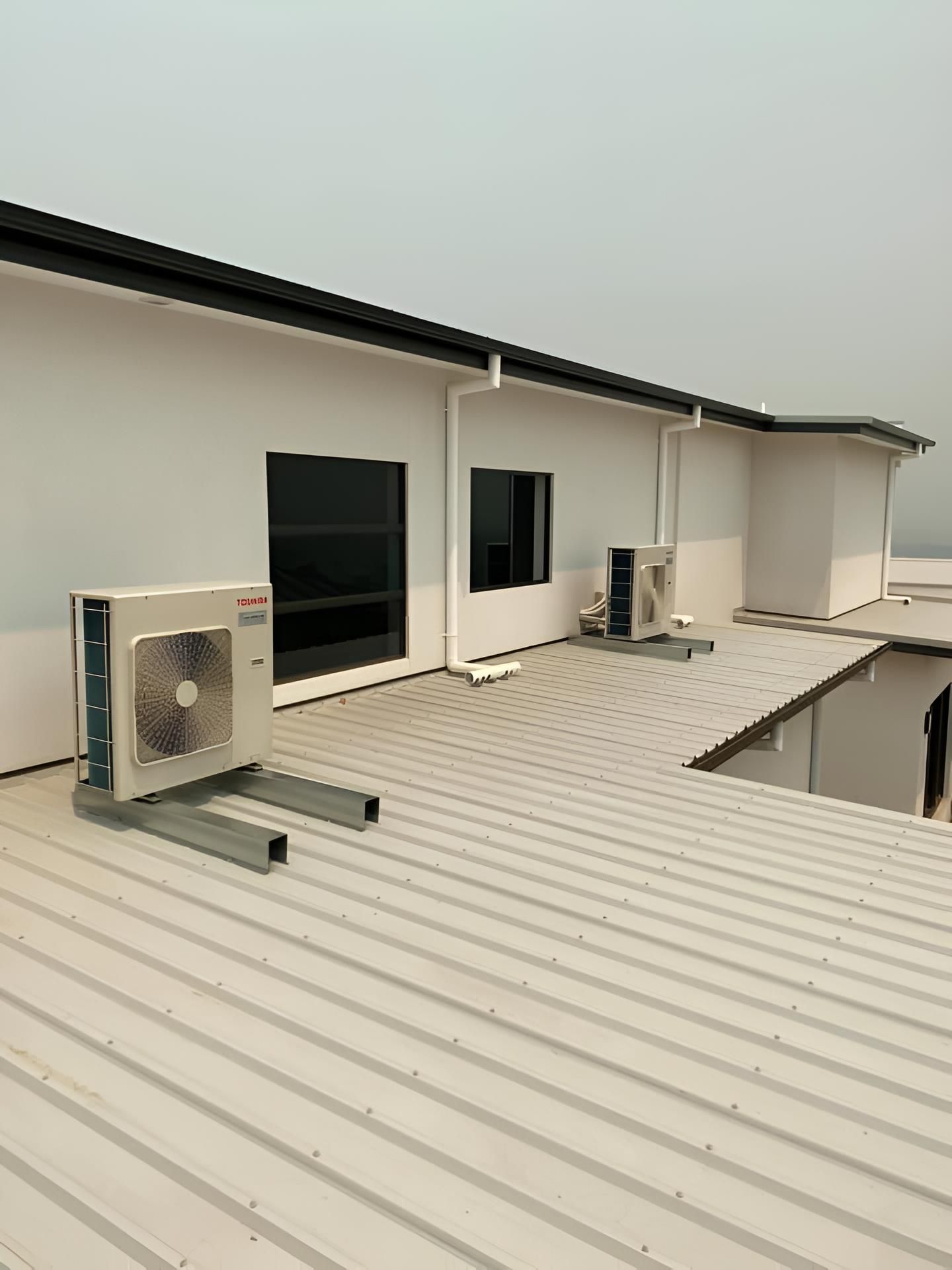 Two Air Conditioners on the Roof of a Building — Air Conditioning Electricians in Forster, NSW