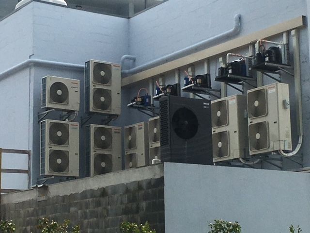 A Row Of Air Conditioners On The Side Of A Building — Aircon Mid North Coast in Forster, NSW