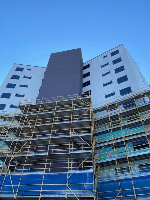 A Large Building Is Being Built With Scaffolding Around It — Aircon Mid North Coast in Forster, NSW