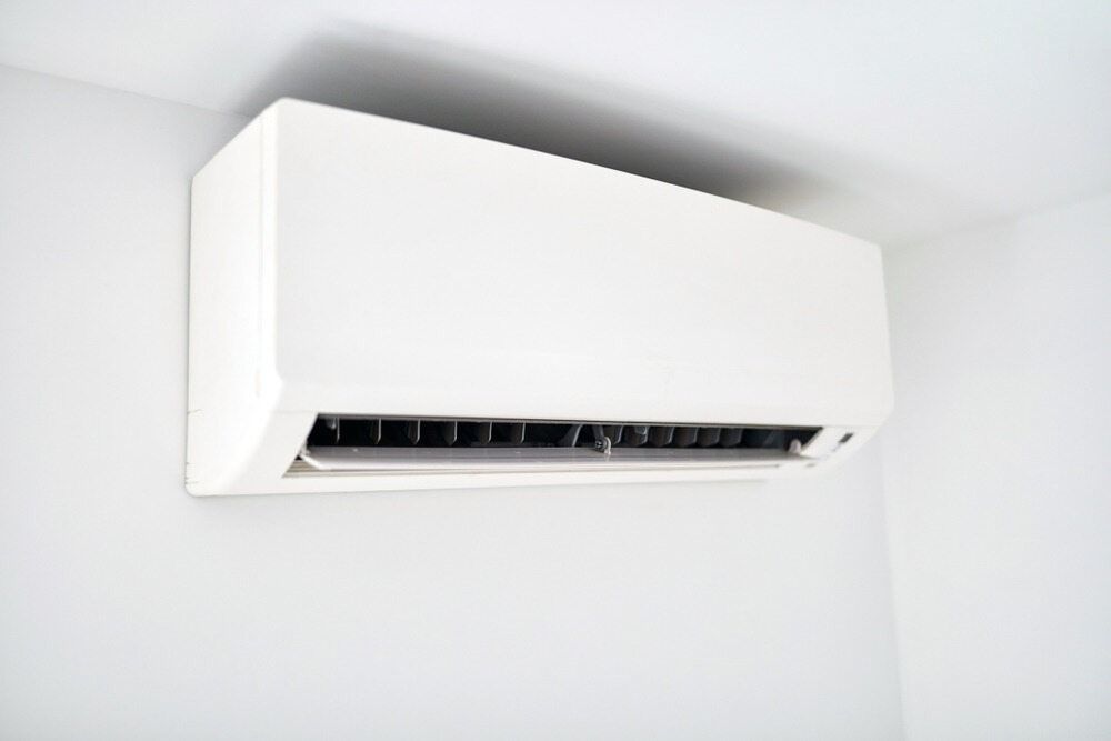 A White Air Conditioner Is Hanging From The Ceiling In A Room — Aircon Mid North Coast in Wauchope, NSW