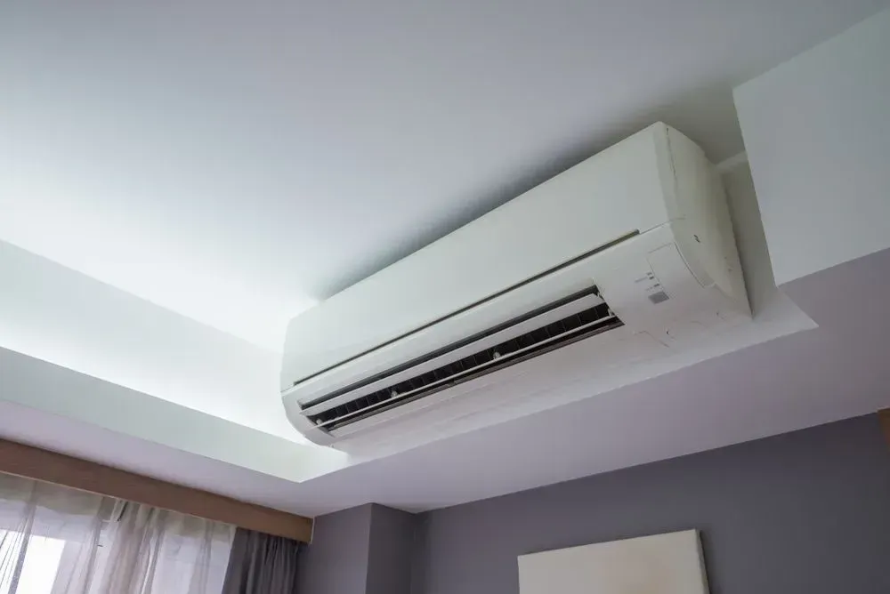 White Air Conditioning Unit Mounted On A White Ceiling