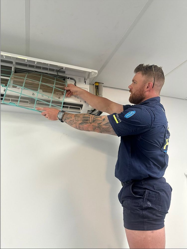 Man in Uniform Installing an Air Conditioner