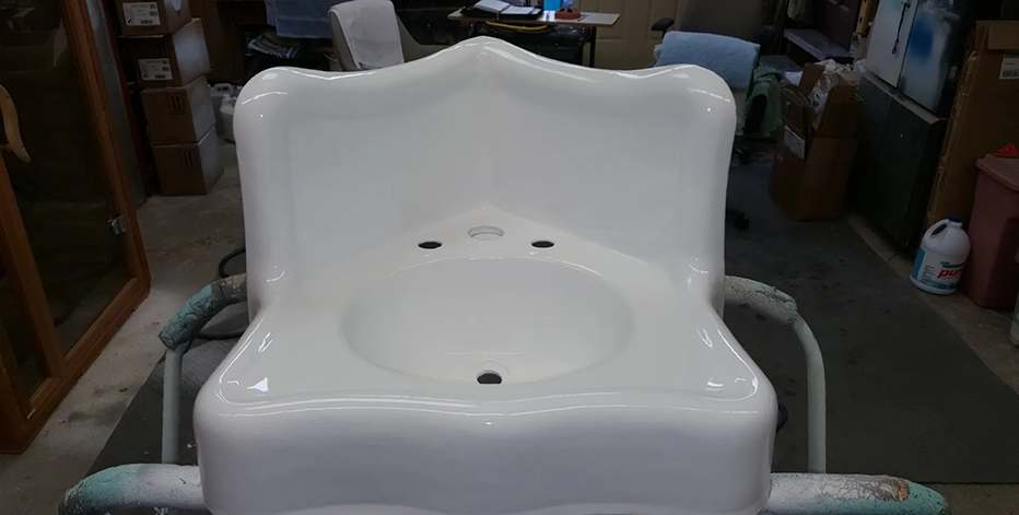 White porcelain corner sink with a high back.