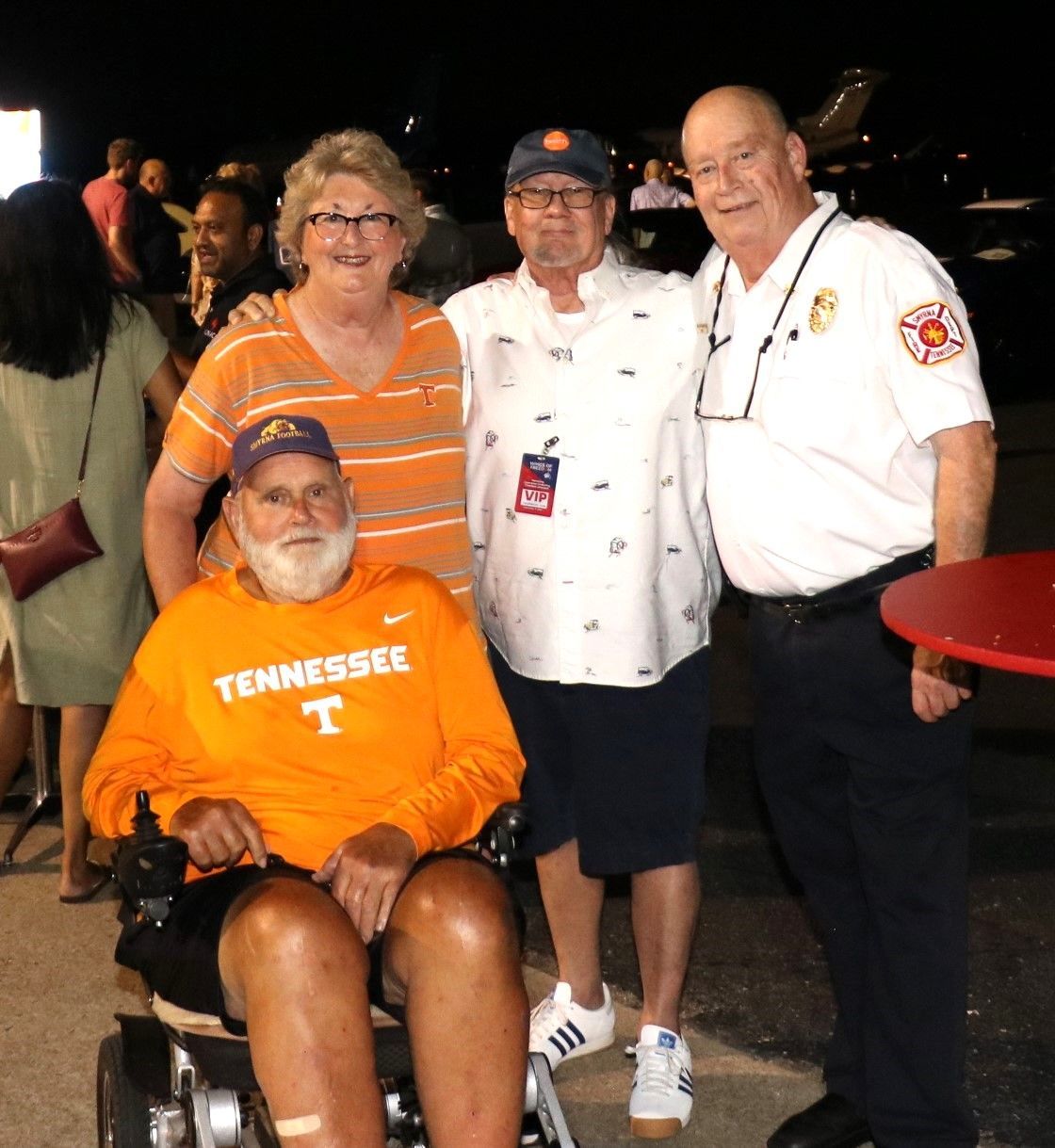 A man in a wheelchair is wearing an orange tennessee shirt