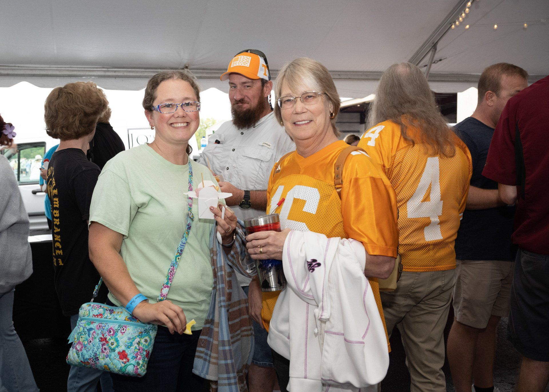 A group of people are posing for a picture in a tent.