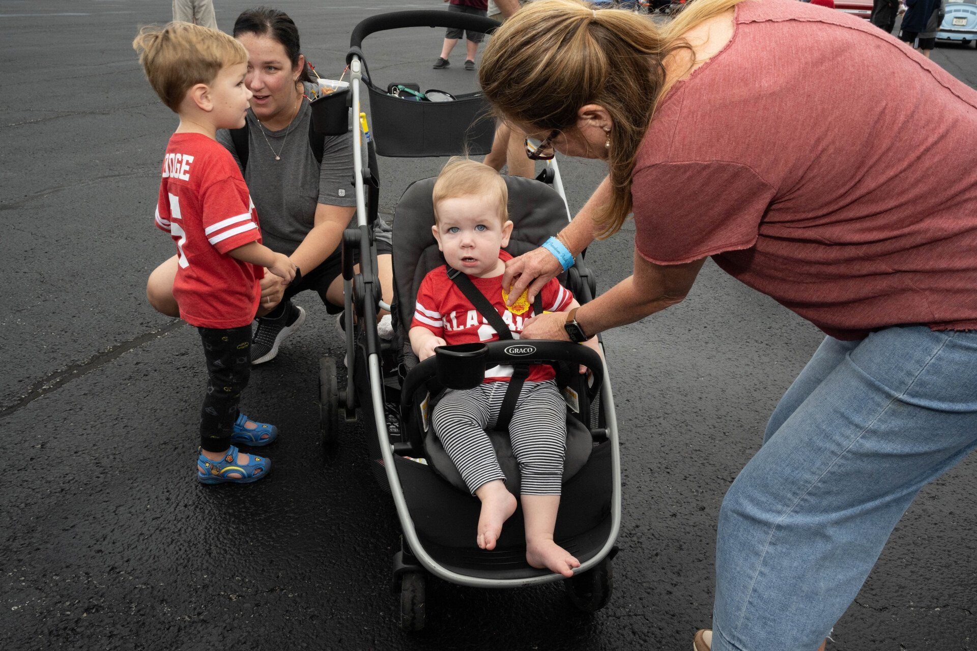 A woman is pushing a baby in a stroller.
